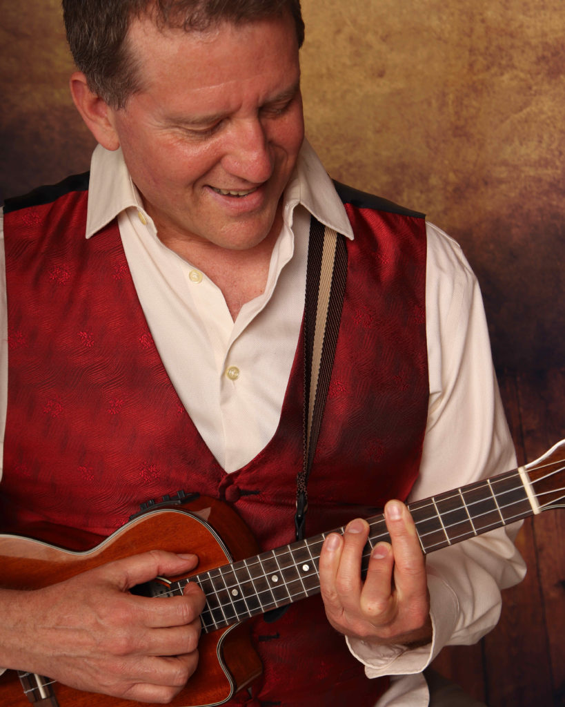 Ken Mattsson Headshot with Ukulele